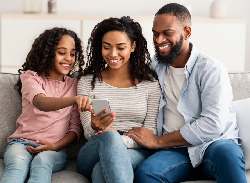 happy-african-american-family-holding-and-using-smartphone.jpg